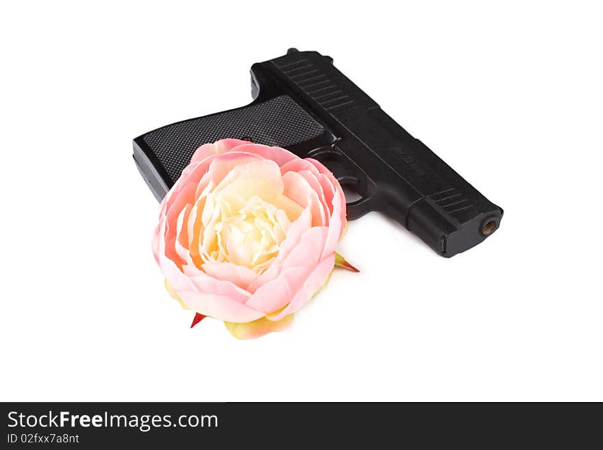 Closeup of pistol and flower isolated over white background. Closeup of pistol and flower isolated over white background