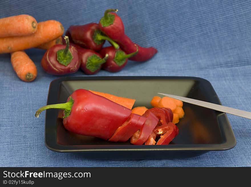 In the kitchen, chopping fresh organic vegetables. In the kitchen, chopping fresh organic vegetables