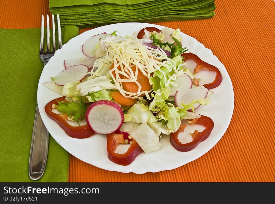 Orange and green table setting, light organic salad