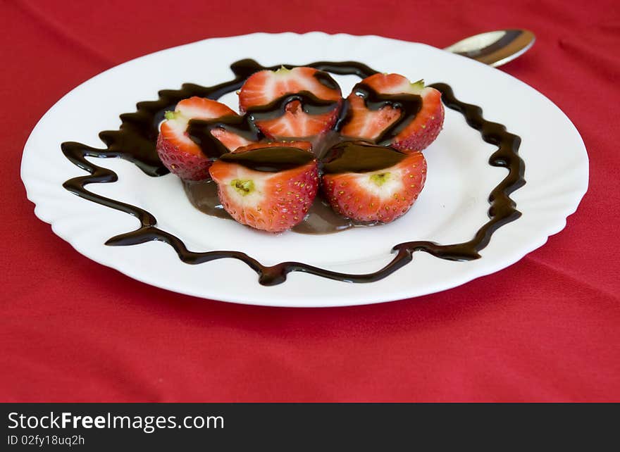 Lovely arrangement of strawberries in chocolate, red background. Lovely arrangement of strawberries in chocolate, red background