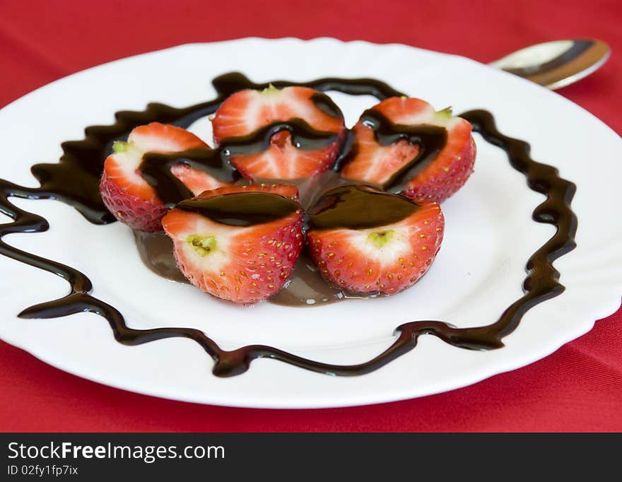 Lovely arrangement of strawberries in chocolate, red background. Lovely arrangement of strawberries in chocolate, red background