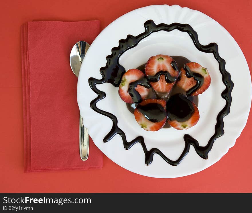 Lovely arrangement of strawberries in chocolate, red background. Lovely arrangement of strawberries in chocolate, red background