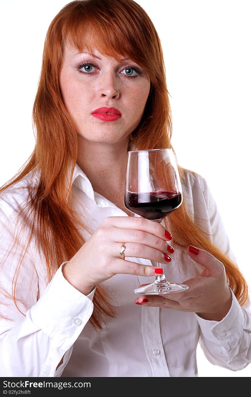 Portrait of a beautiful redhead girl with a glass of red wine