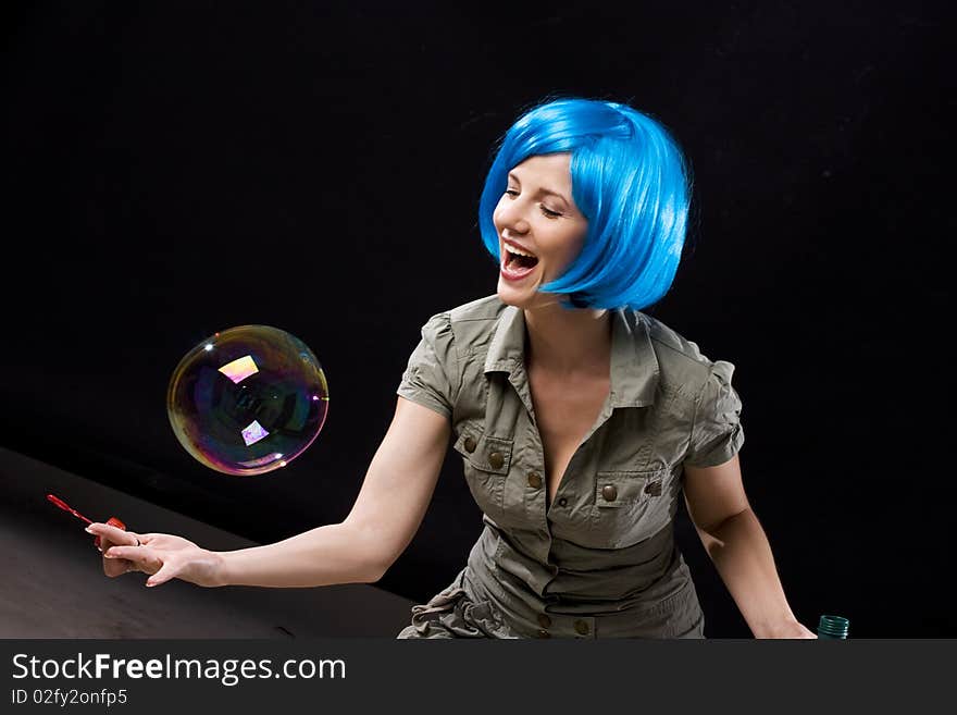 Woman in blue wig with soap bubbles. Woman in blue wig with soap bubbles