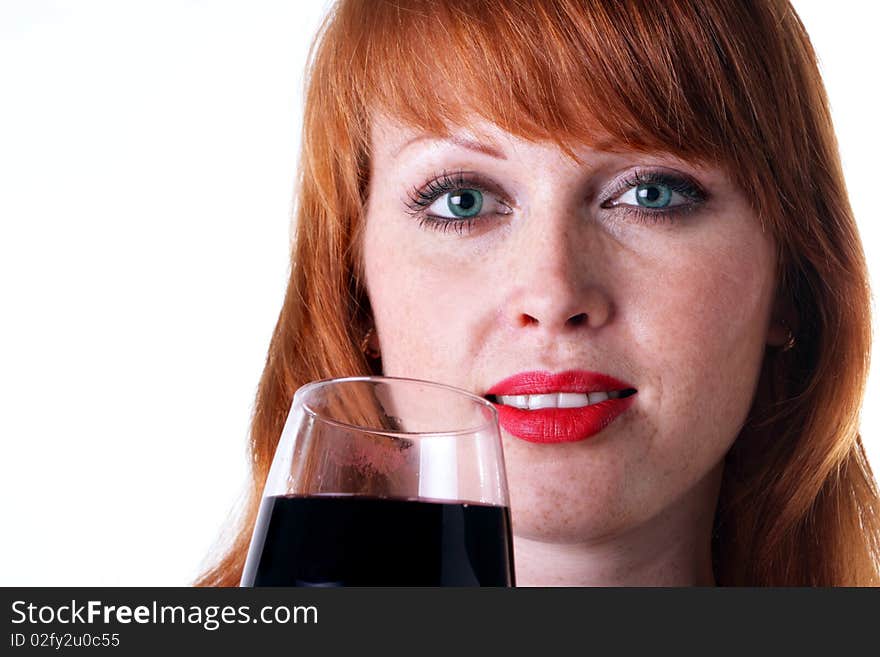 Beautiful redhead girl with a glass of red wine