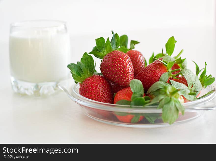 Fresh strawberries and a glass of milk. Fresh strawberries and a glass of milk