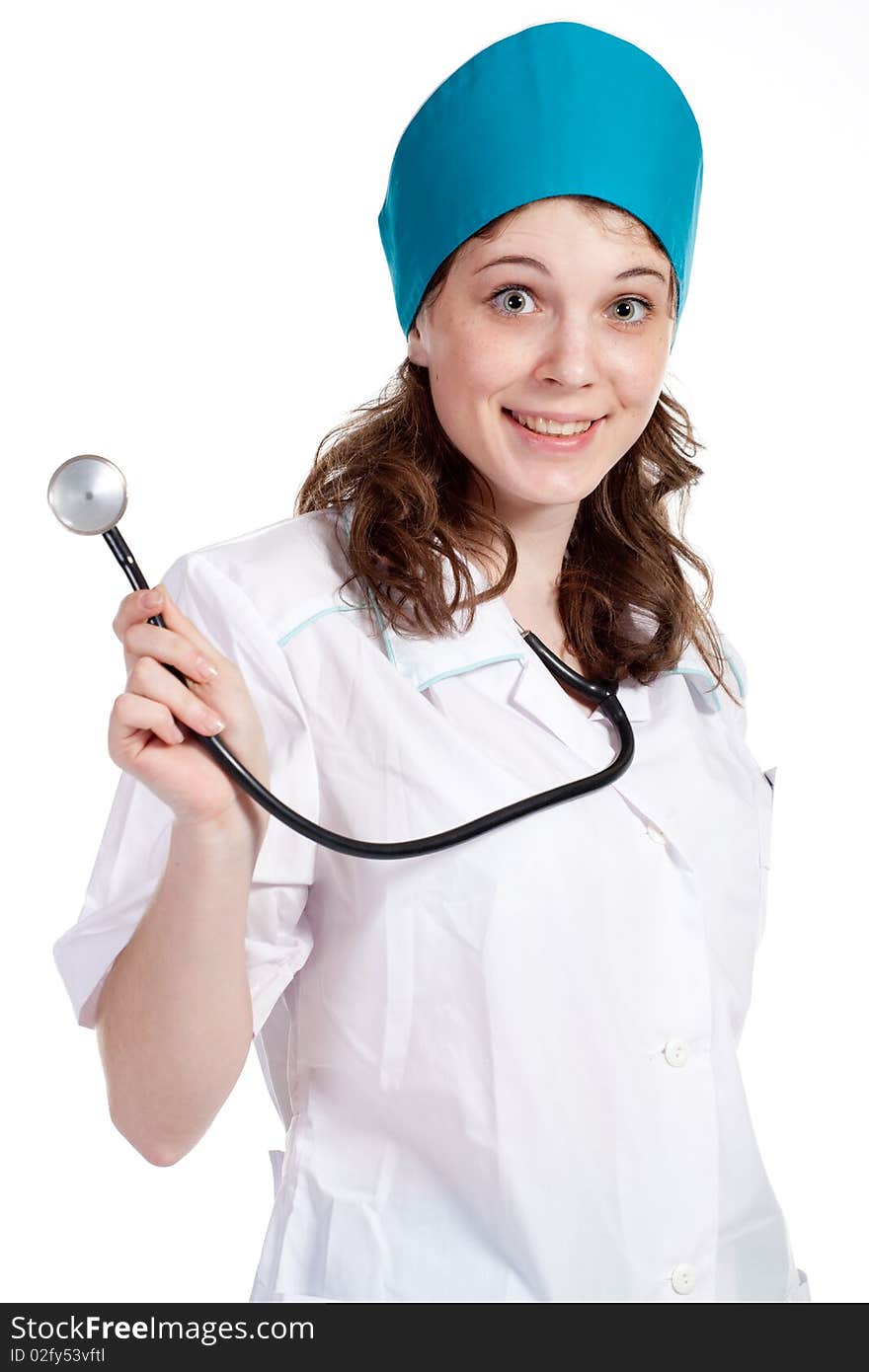 Attractive young female doctor holds a stethoscope, isolated on white background