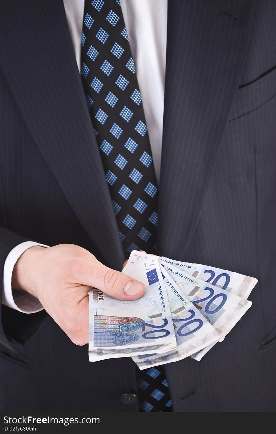 Businessman in suit holding euro notes.