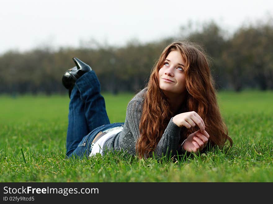 Relaxign girl on green grass