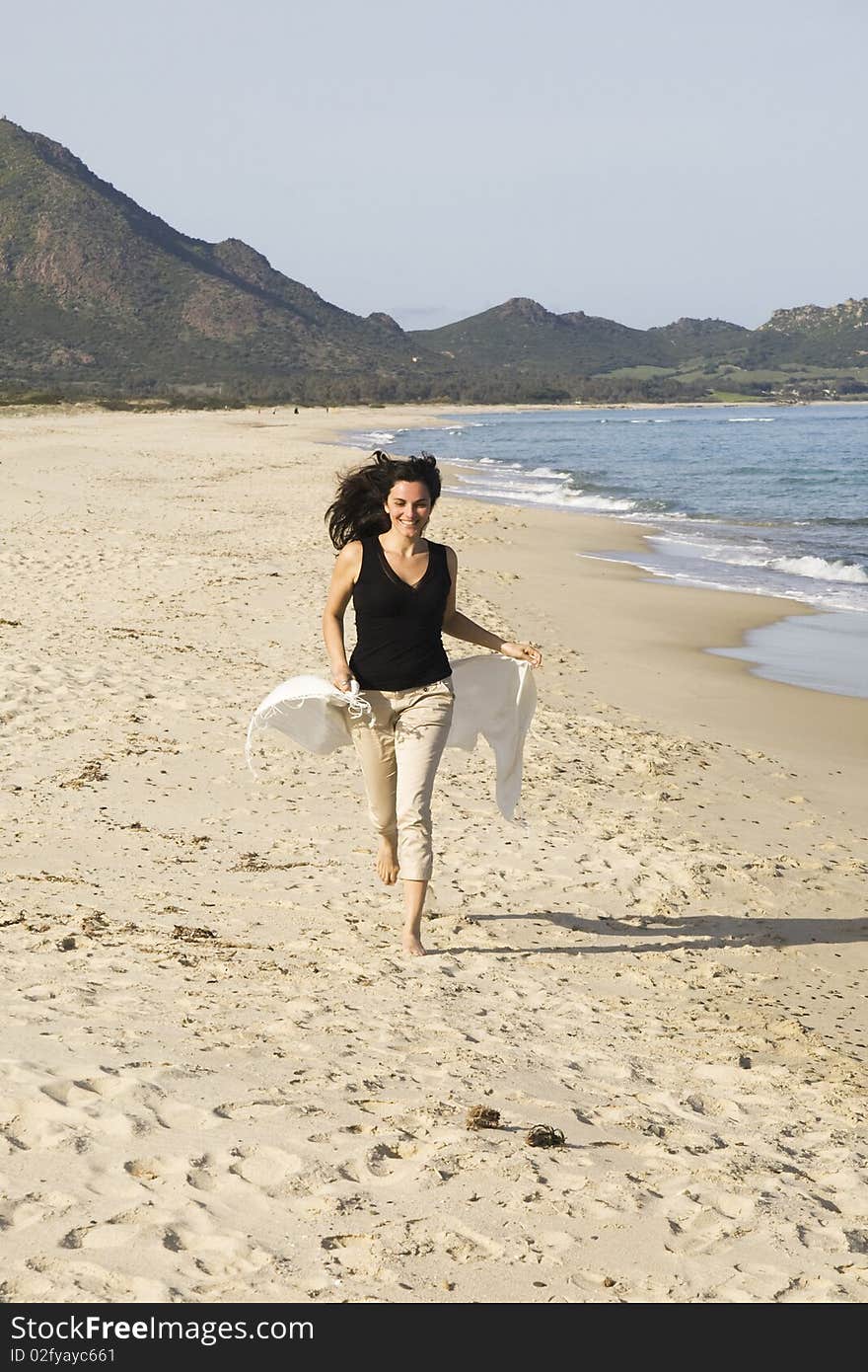 Young woman running on the beach