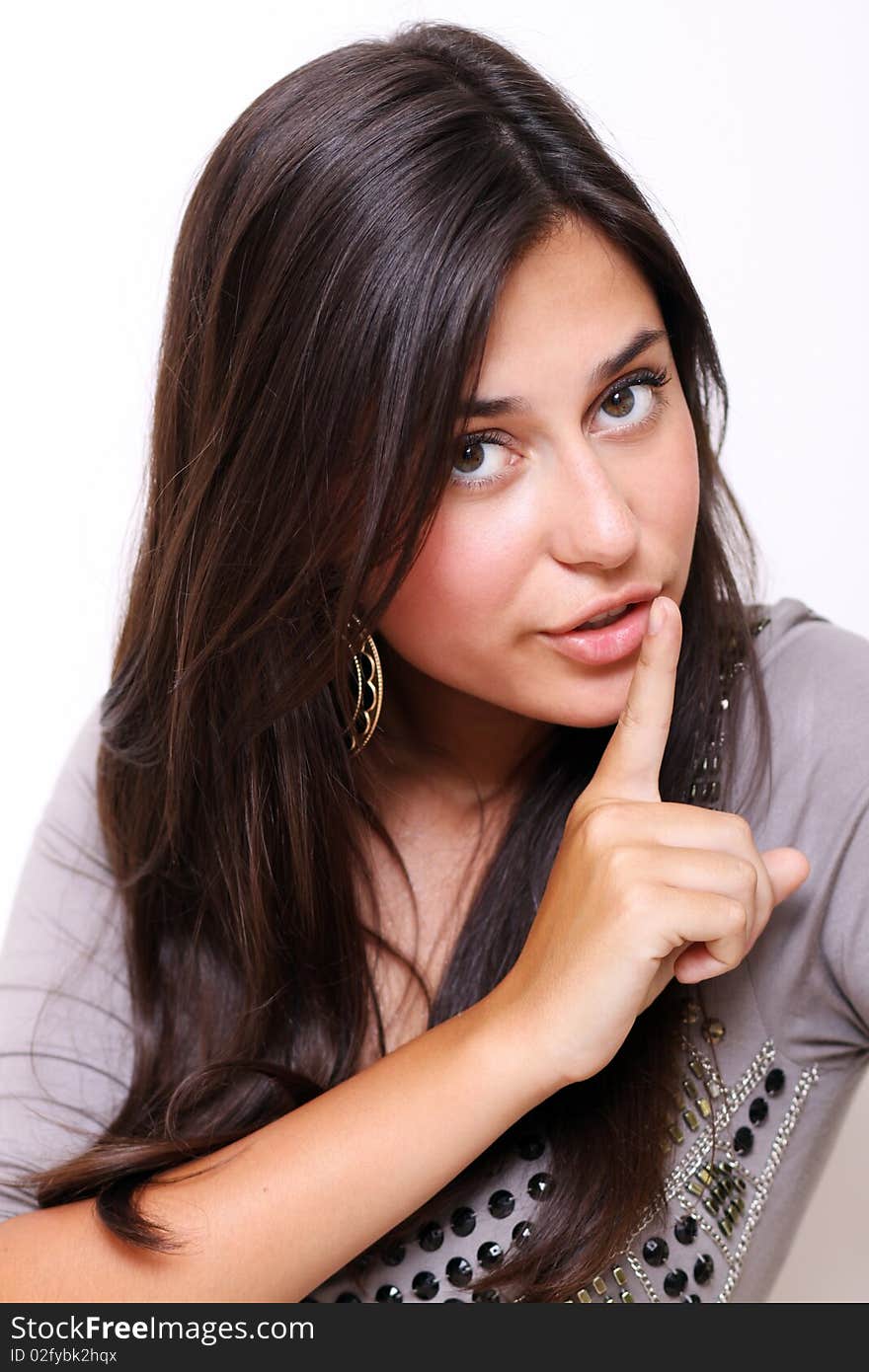 Portrait of young woman with silence sign isolated on white background