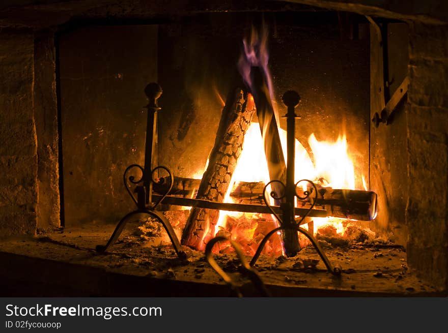 A set of logs burning inside a fireplace gives a warm feeling. A set of logs burning inside a fireplace gives a warm feeling