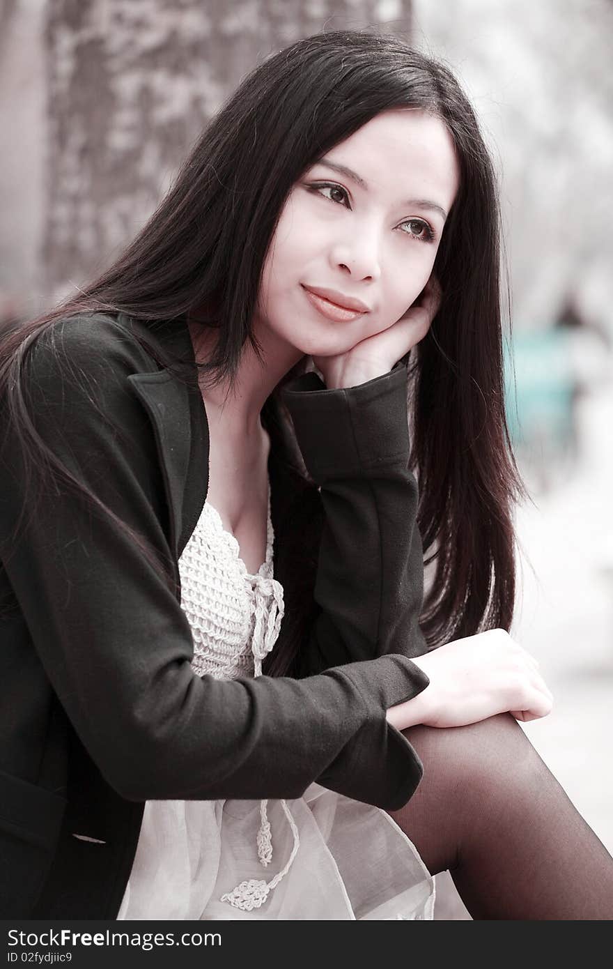 Young Asian woman with long hair sitting and enjoying the scenery in spring. Young Asian woman with long hair sitting and enjoying the scenery in spring.