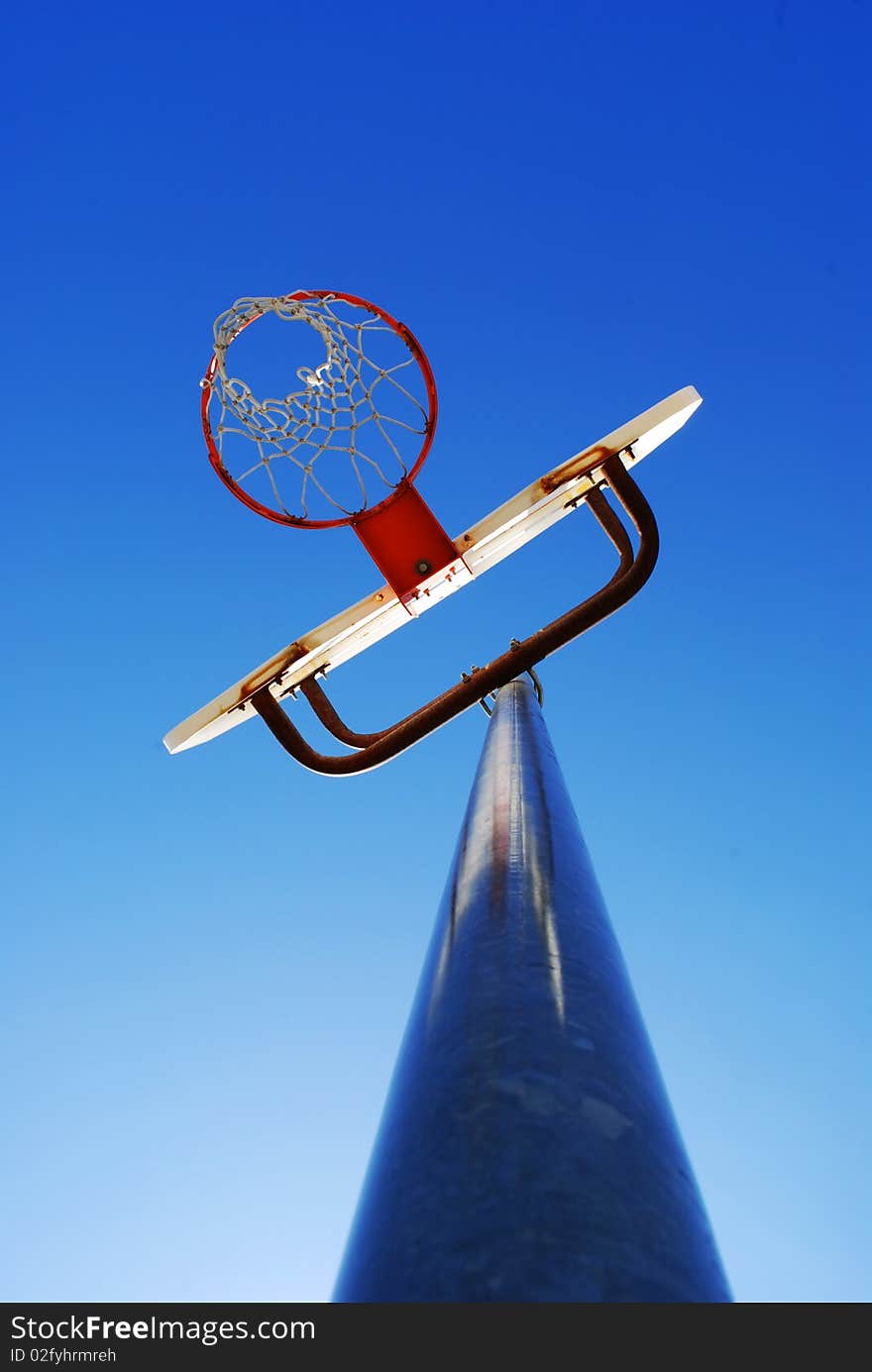 Basketball hoop with blue sky in the background