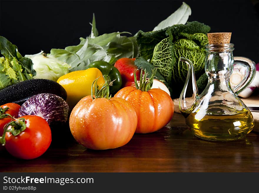 A wooden table spread of fresh vegetables