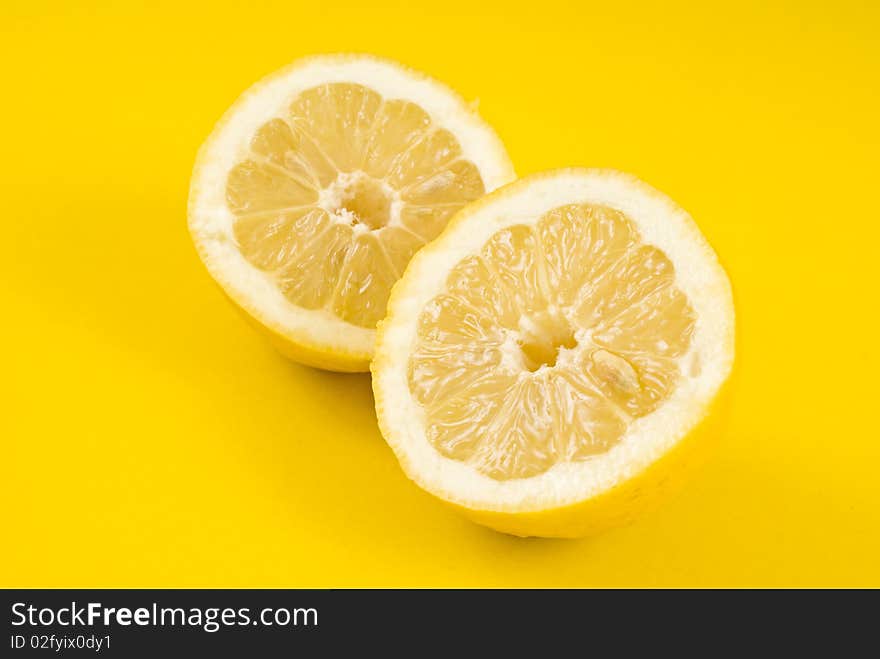 Two half lemon on yellow background