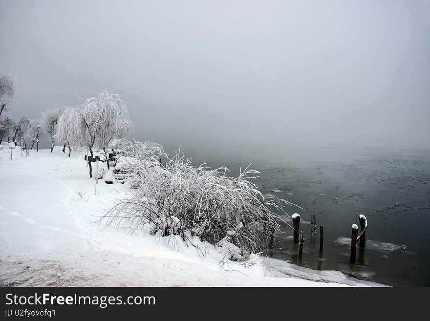 A misty snowy day near a romanian lake. A misty snowy day near a romanian lake