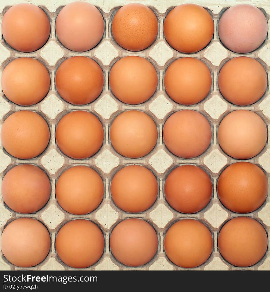 Background of brown eggs in a protective container