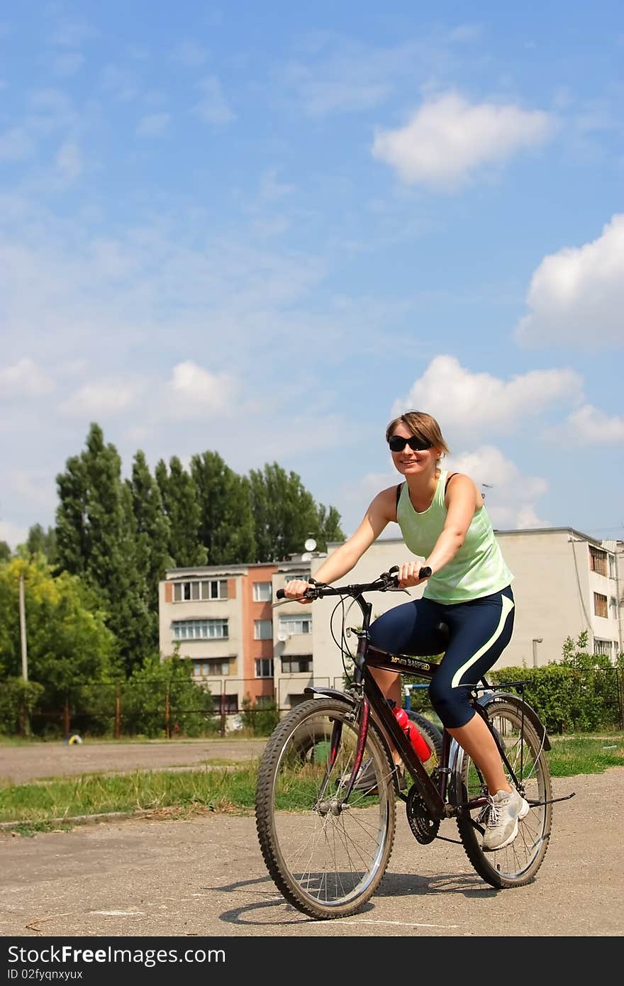 Woman cycling in a park sunny day