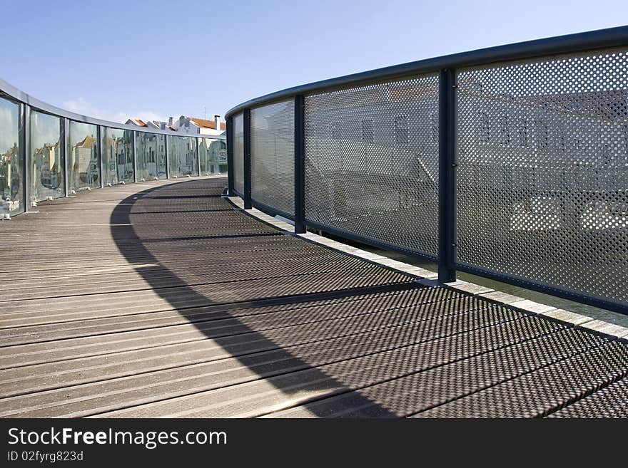 Wooden bridge and rails. A pathway into a urbanscape. Wooden bridge and rails. A pathway into a urbanscape