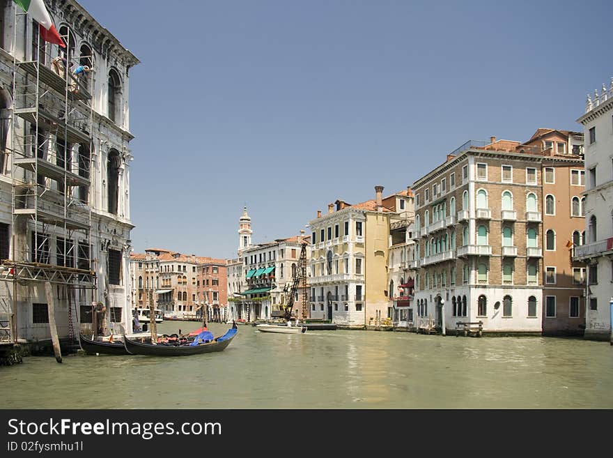 Boats at venetian canal among old and multicolored houses in (Grand canal, Venice, Italy). Boats at venetian canal among old and multicolored houses in (Grand canal, Venice, Italy)