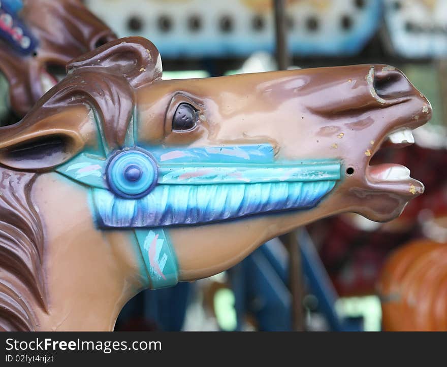 A close up picture of a horses head on a merry go round. A close up picture of a horses head on a merry go round.