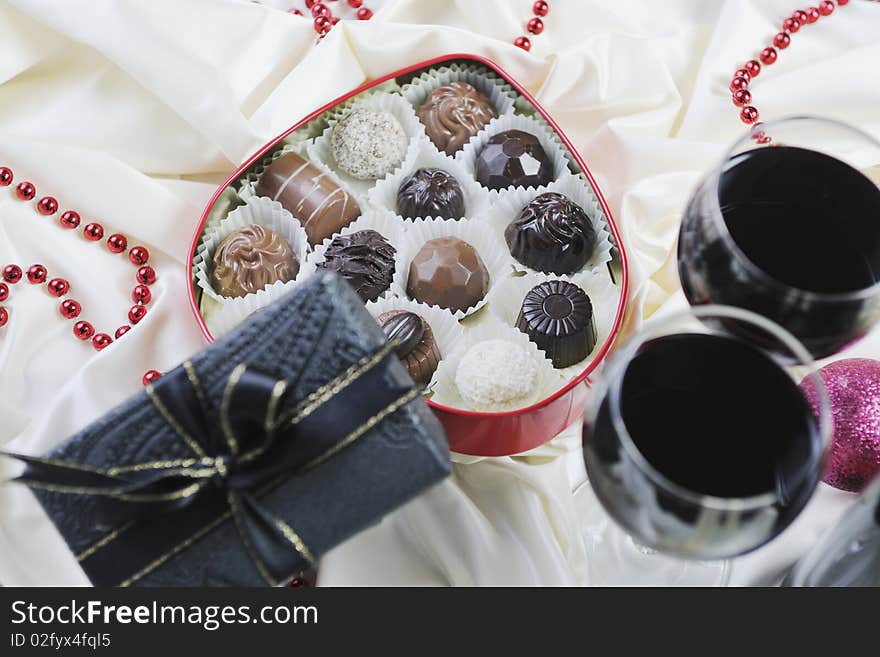 Luxury and sweet praline and chocolate with wine bottle and glasses  decoration. Luxury and sweet praline and chocolate with wine bottle and glasses  decoration