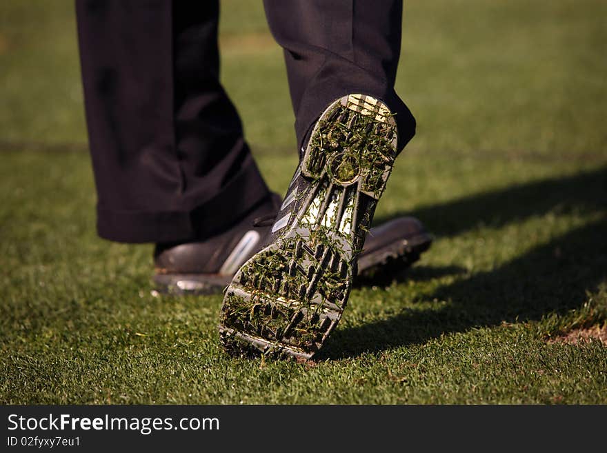 Bottom of golfer's shoe on the follow through after ball is hit. Bottom of golfer's shoe on the follow through after ball is hit.