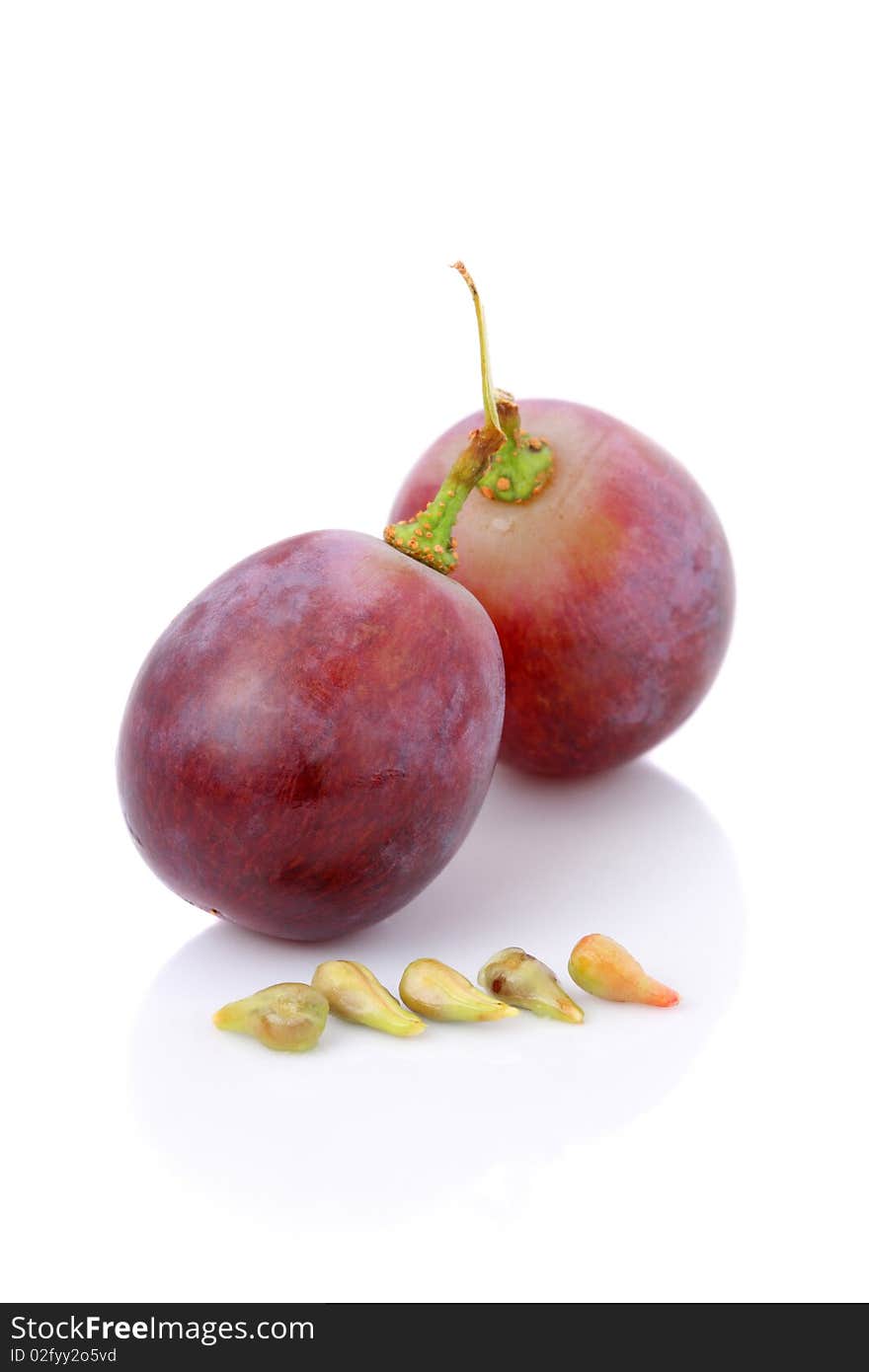 An half and fullness grapes with seeds isolated over white background.