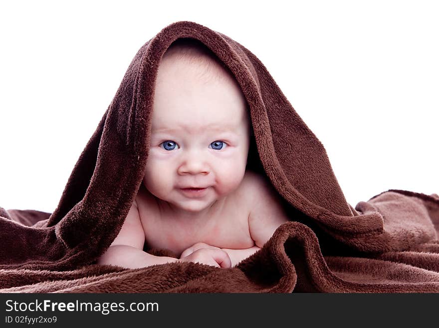 A Beautiful Baby Under A Brown Towel