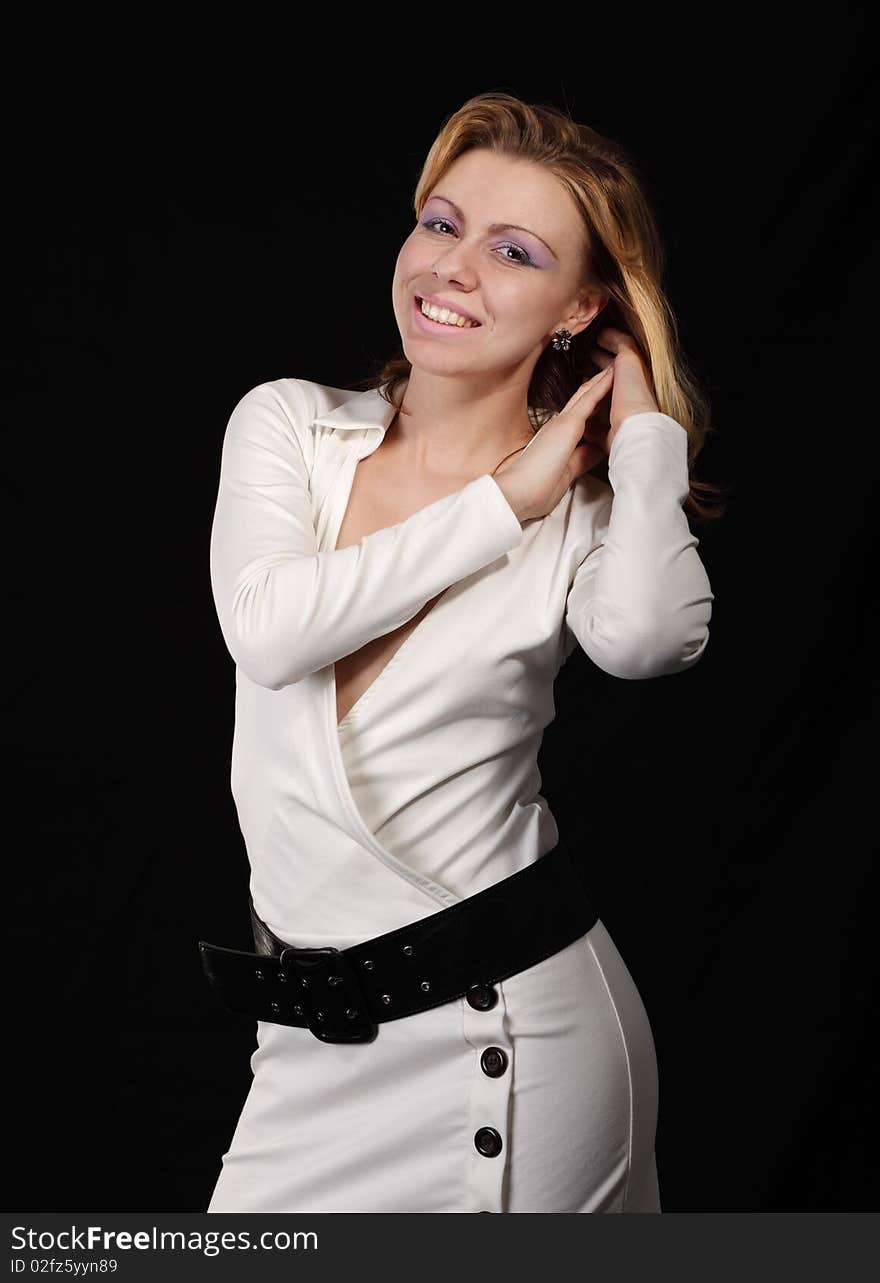 The girl in a white dress on a black background