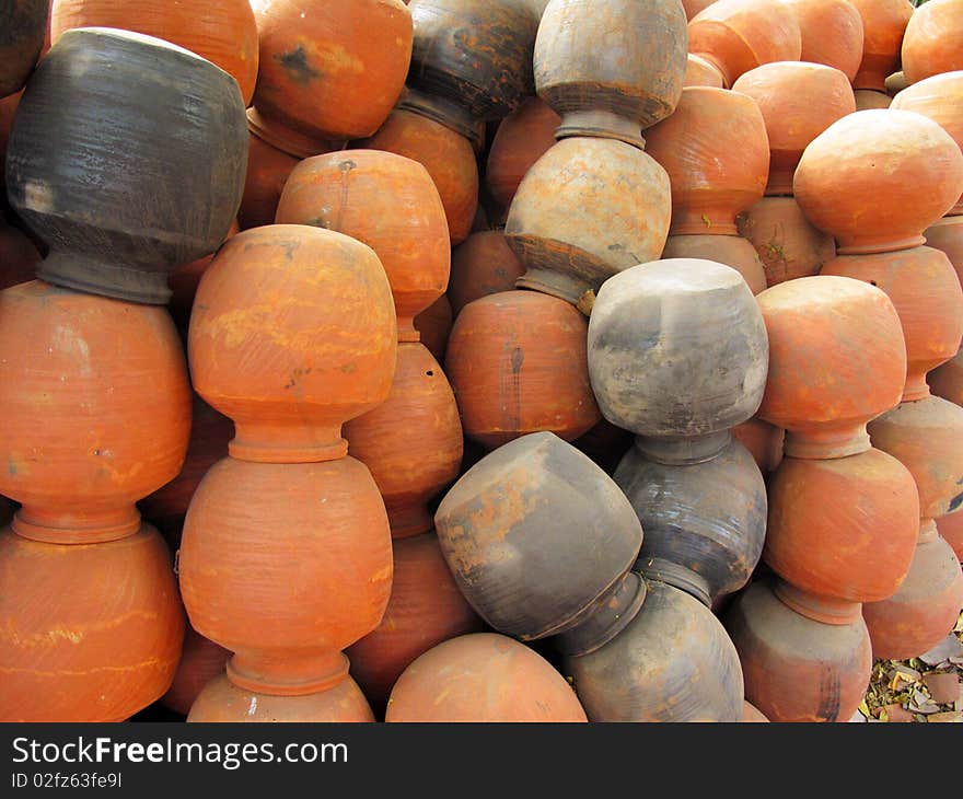 Many clay pots at a potters shop used for storing water in summer in india. Many clay pots at a potters shop used for storing water in summer in india