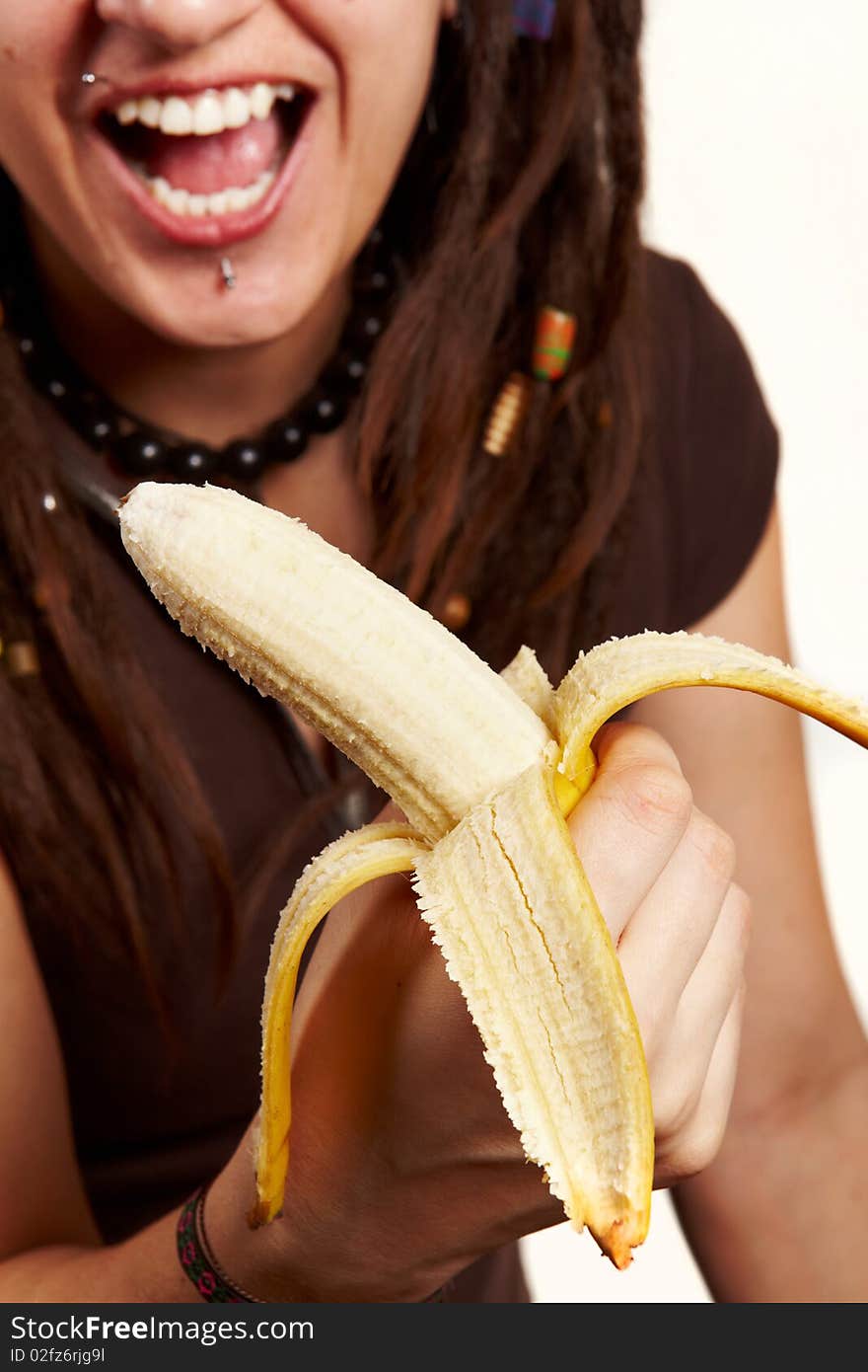 Girl with dreadlocks carring fresh banana isolated. Girl with dreadlocks carring fresh banana isolated