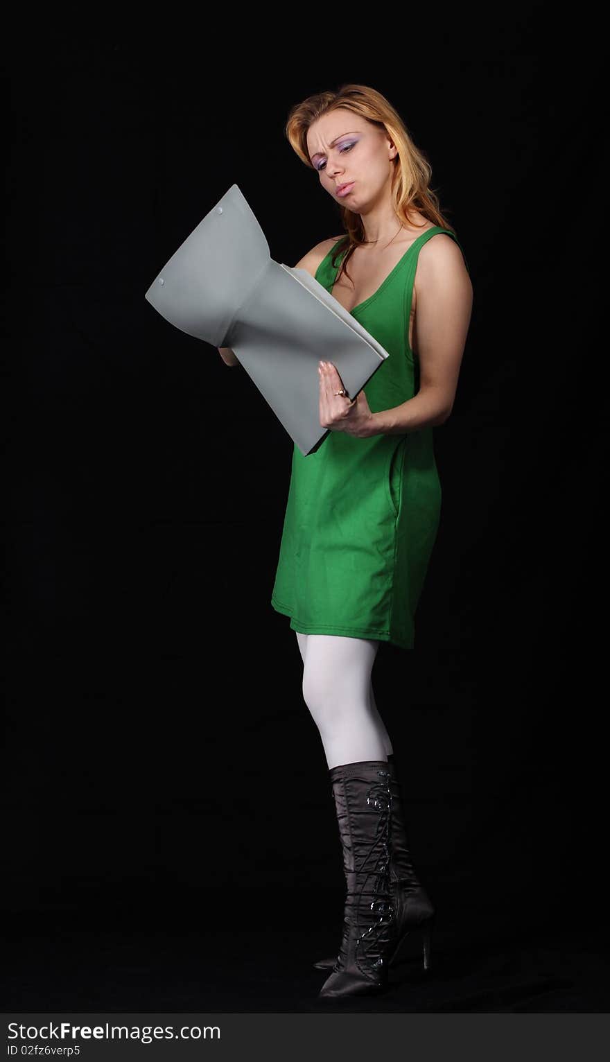 The girl with a folder on a black background