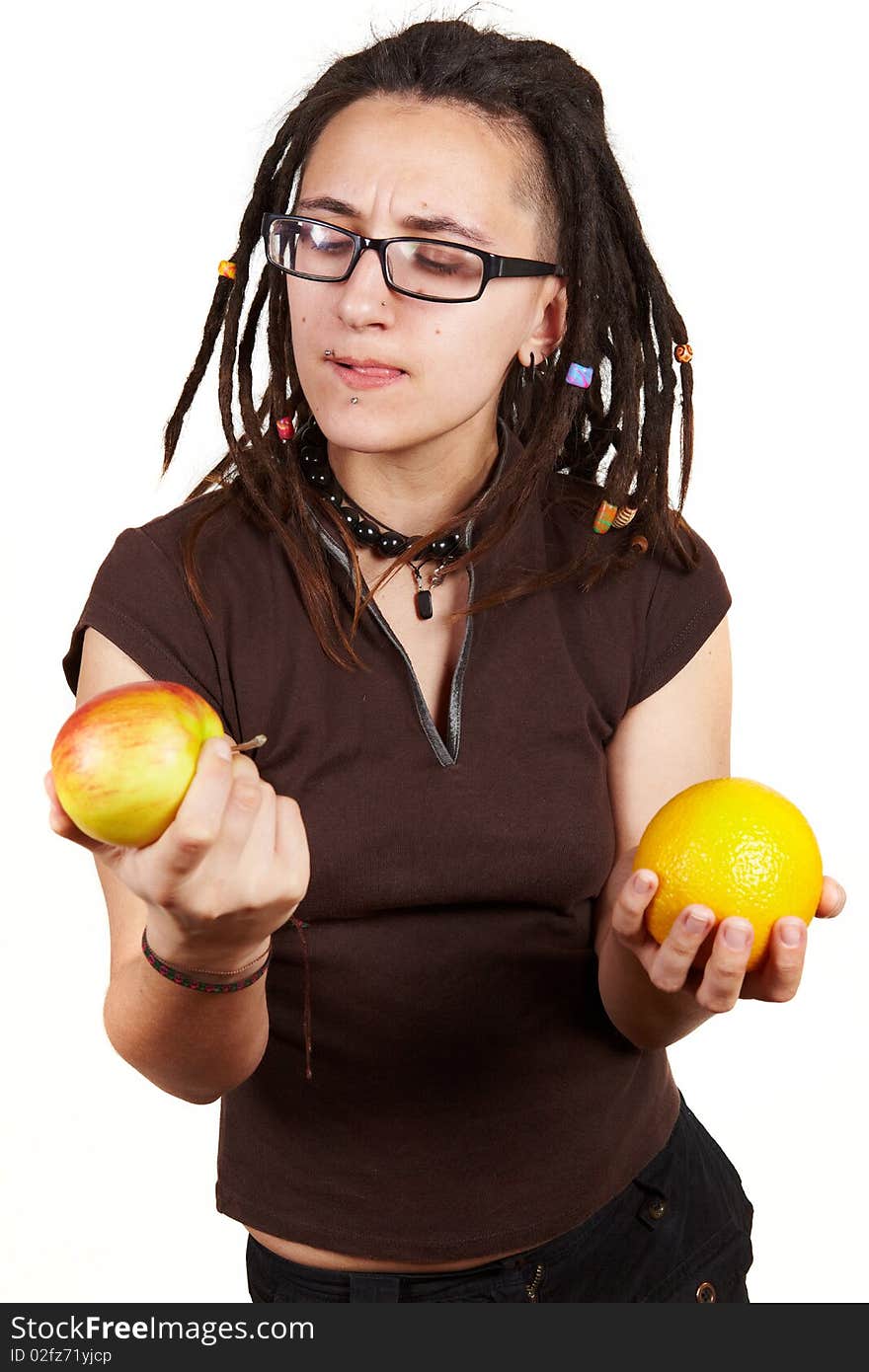 Girl with dreadlocks choise between apple and orange. Girl with dreadlocks choise between apple and orange