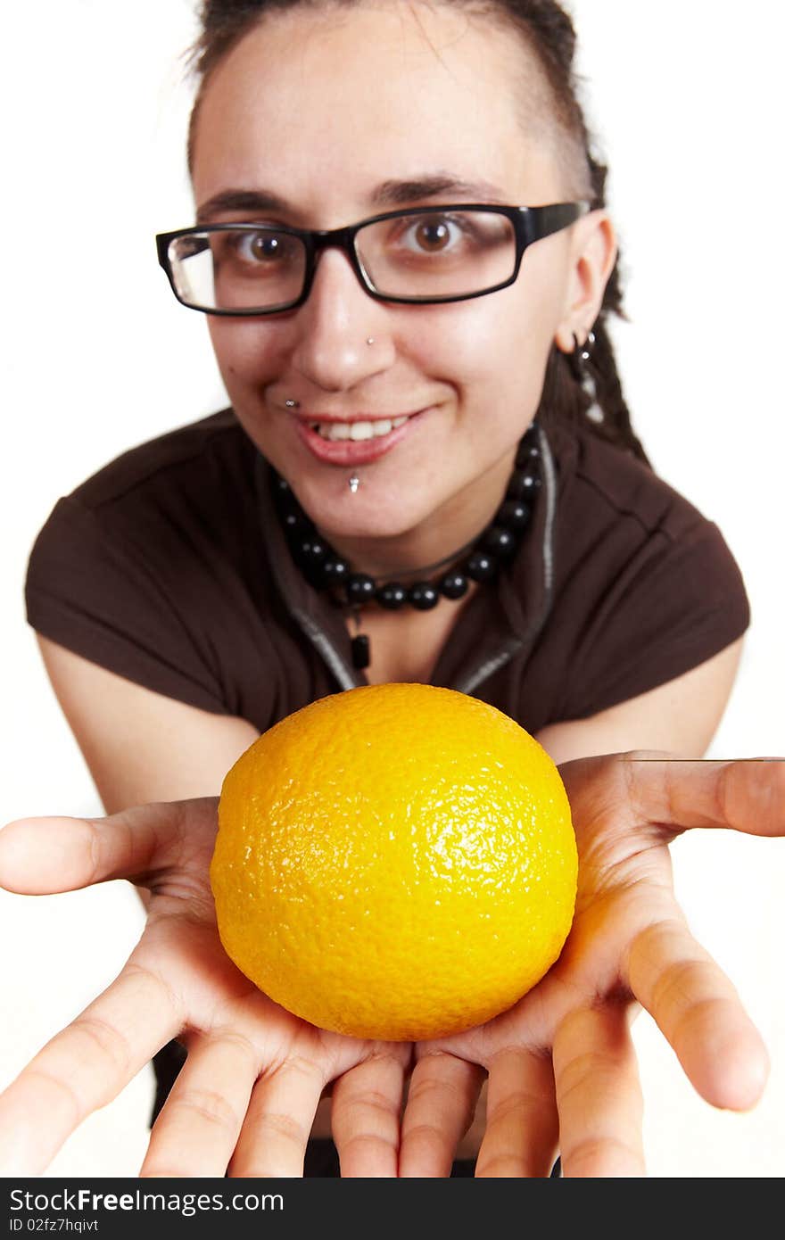 Girl with dreadlocks present an orange, isolated. Girl with dreadlocks present an orange, isolated