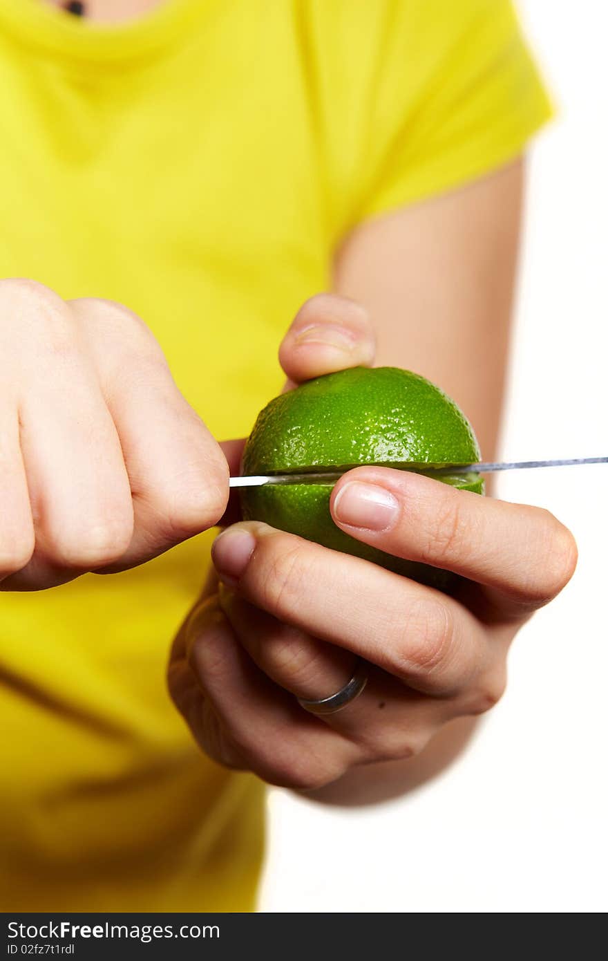 Girl in yellow snip fresh lime on isolated background. Girl in yellow snip fresh lime on isolated background