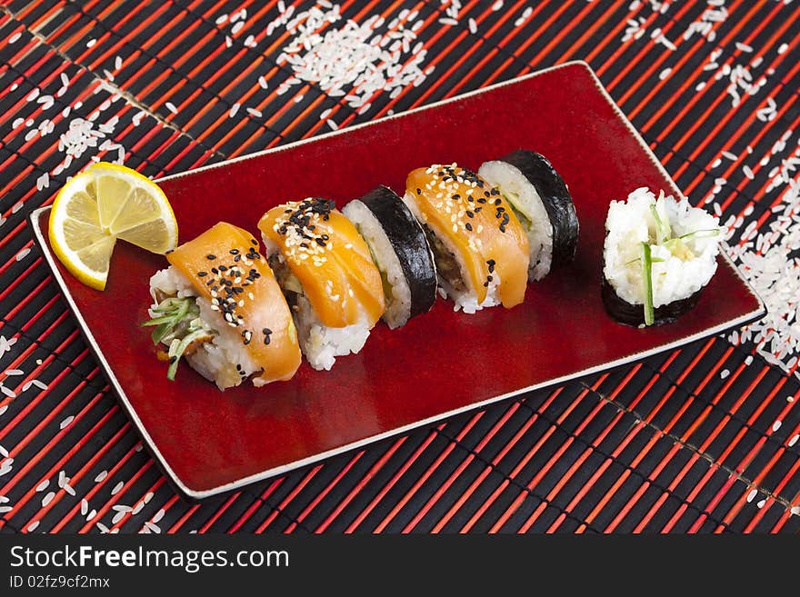 A complete sushi meal with chopsticks on tatami mat