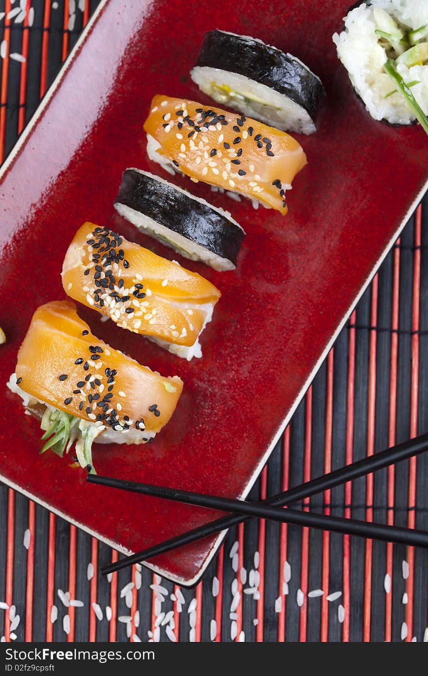 A complete sushi meal with chopsticks on tatami mat