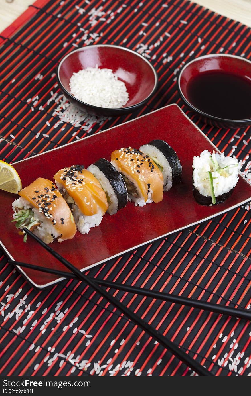 A complete sushi meal with chopsticks on tatami mat