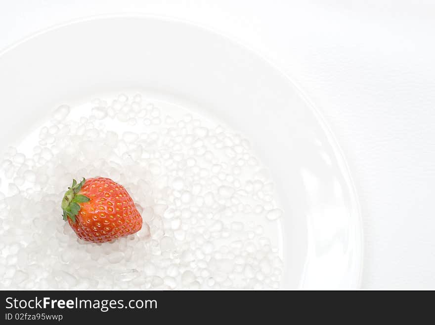 Strawberry and Glass Sand on the plate. Strawberry and Glass Sand on the plate