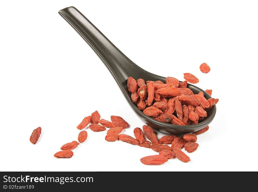 Goji Berries On A Black Spoon