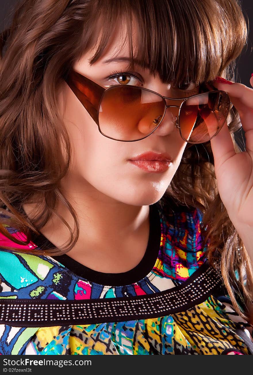 Image of playful model wearing sunglasses. Image of playful model wearing sunglasses