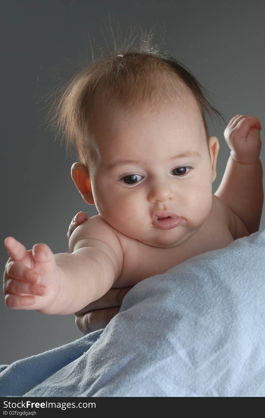 Child in in arms no wear on grey background. Child in in arms no wear on grey background