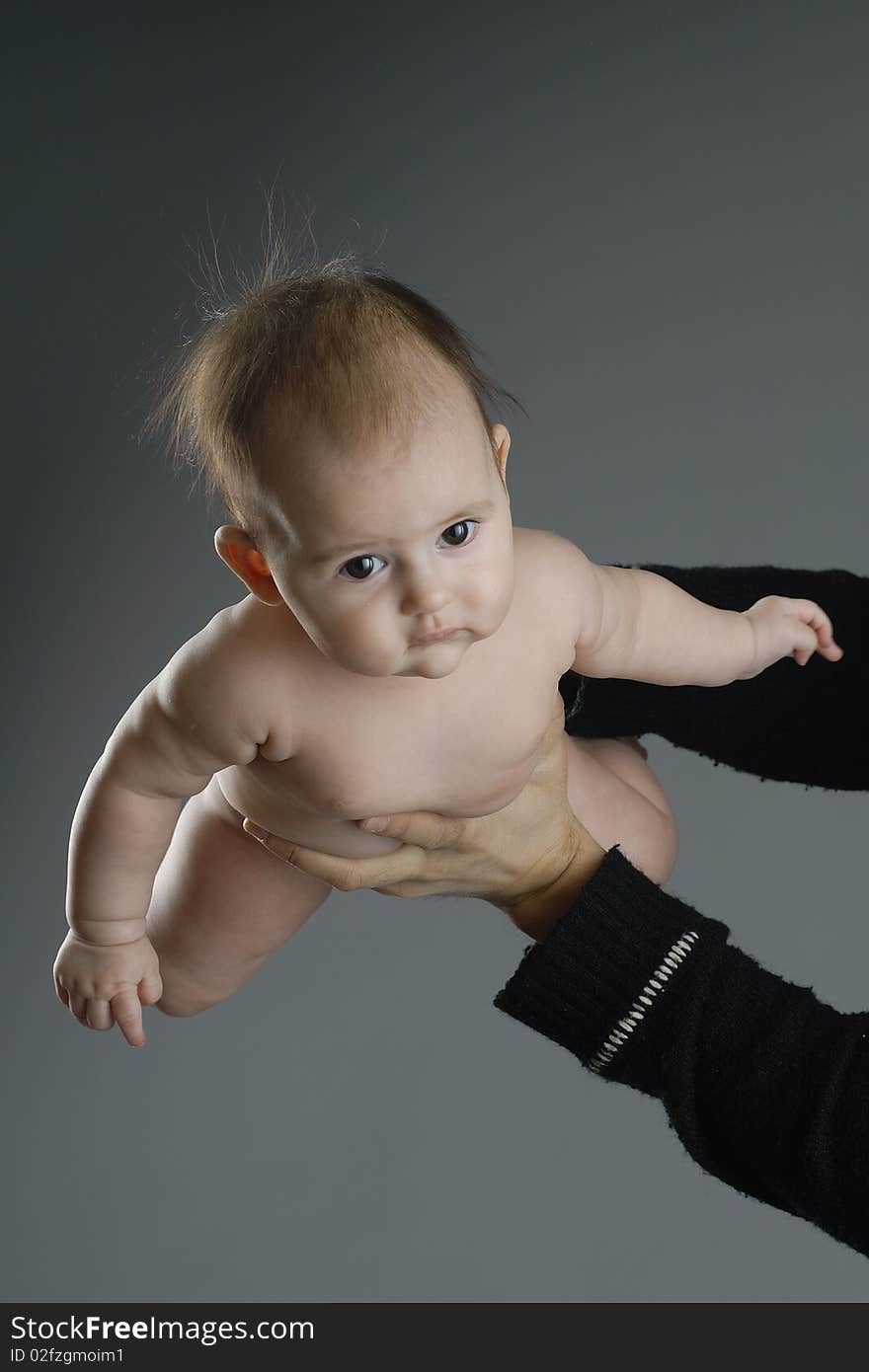 Child in in arms no wear on grey background. Child in in arms no wear on grey background