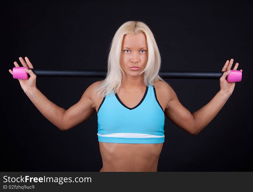 Image of sexy athlete holding fitness bar on her sholders. Image of sexy athlete holding fitness bar on her sholders