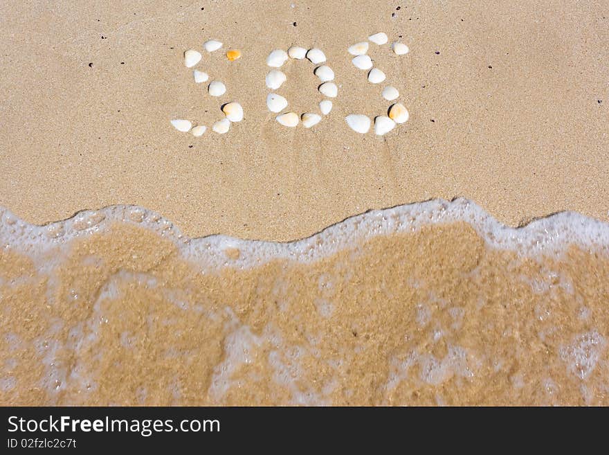 SOS in sand on a beach