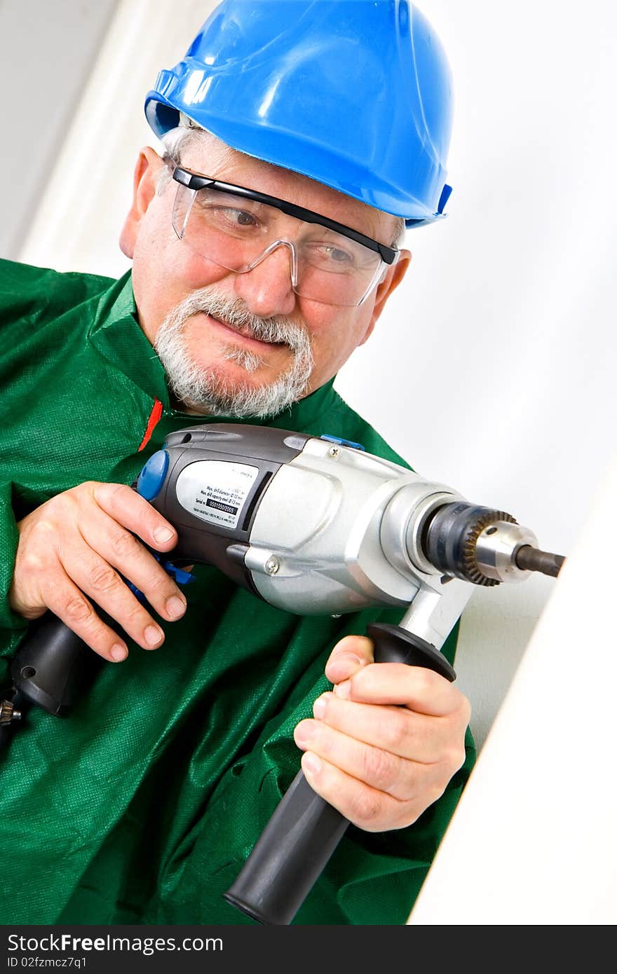 Construction worker holding the electric hand drill. Construction worker holding the electric hand drill