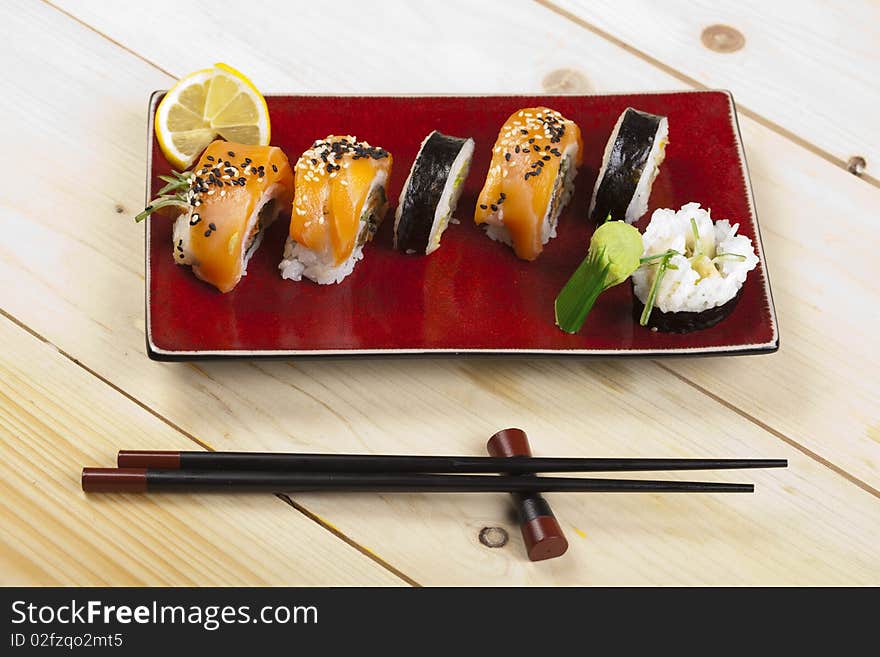 A complete sushi meal with chopsticks on wood