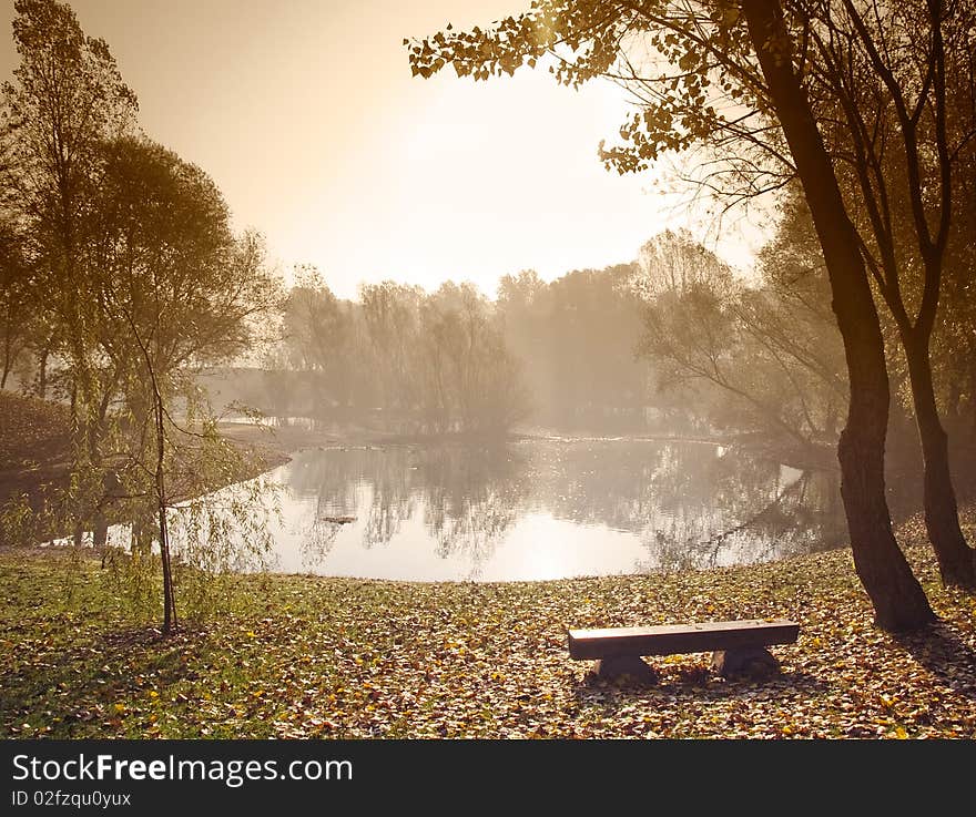 Early morning over small lake with sepia toned sky. Early morning over small lake with sepia toned sky.